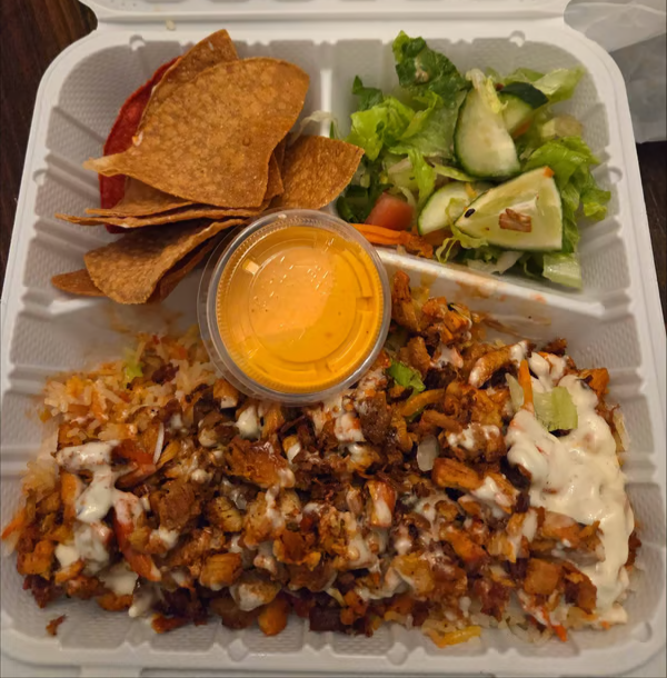 Chicken Over Rice with salad, tortilla chips and sauce from Taco Time's Fulton menu